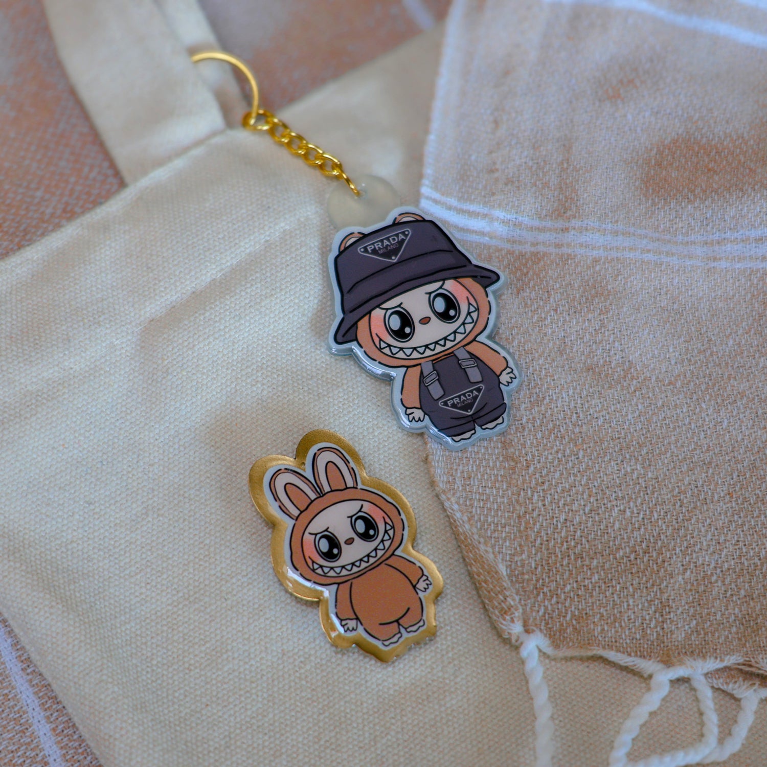 Handmade Labubu pin with gold butterfly clasp, and handmade Labubu keychain with gold chain, featuring a cute character design, perfect for accessorizing bags, jackets, or ita bags. Created by Avocado Artt