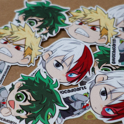 Handmade vinyl stickers of Bakugo, Midoriya, and Todoroki from My Hero Academia, illustrated by Avocado Artt in a cohesive trio design featuring each hero in their signature poses and outfits.
