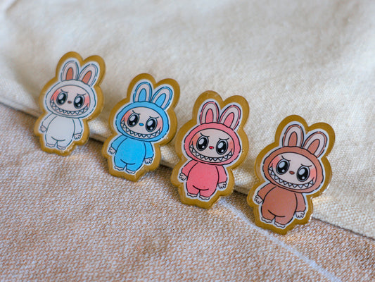 Handmade Labubu pin with gold butterfly clasp, featuring a cute character design, perfect for accessorizing bags, jackets, or ita bags. Created by Avocado Artt.