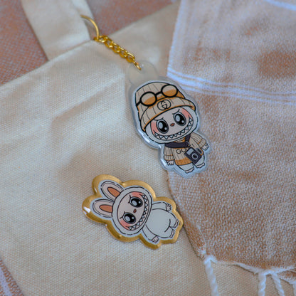 Handmade Labubu pin with gold butterfly clasp, featuring a cute character design, perfect for accessorizing bags, jackets, or ita bags. Created by Avocado Artt.