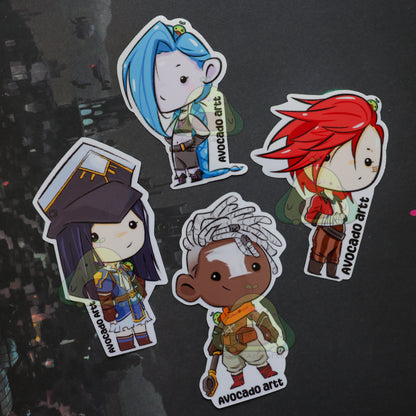 Four colorful stickers of animated characters on a dark background