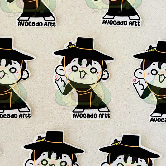 Stickers of a character in a black hat and outfit with 'Avocado Artt' branding on a beige background.