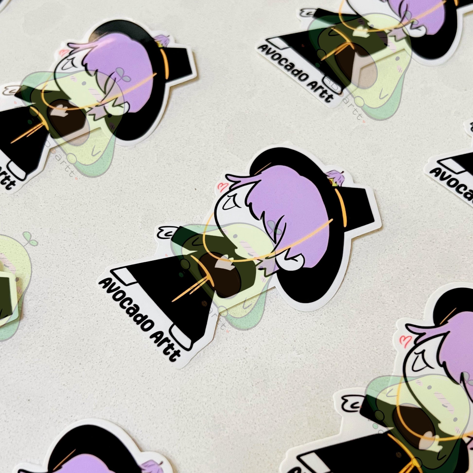 Stickers with an animated character and 'Avocado Art' text on a light background